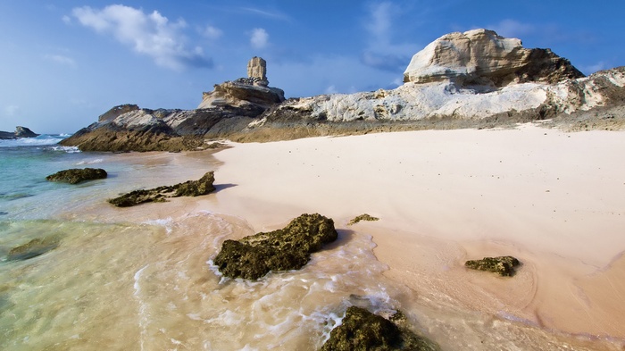 Rocky beach with white sand and turquoise water