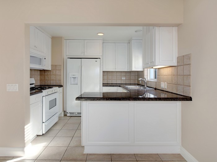 Kitchen with white cabinets and granite countertops