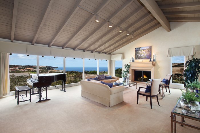 Living room with grand piano and fireplace