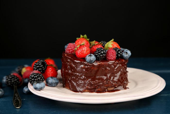 Chocolate cake with fresh berries on a plate
