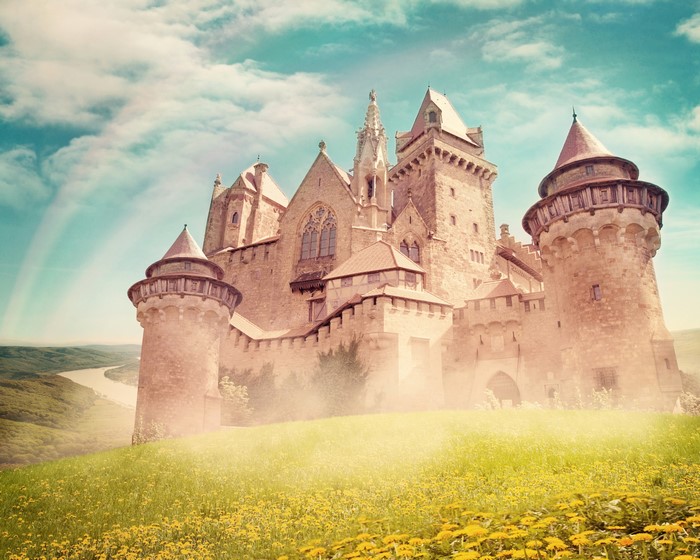 Castle on a hill with rainbow and fields