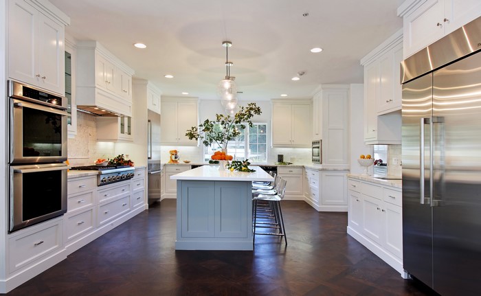 Modern white kitchen with island and stainless steel appliances