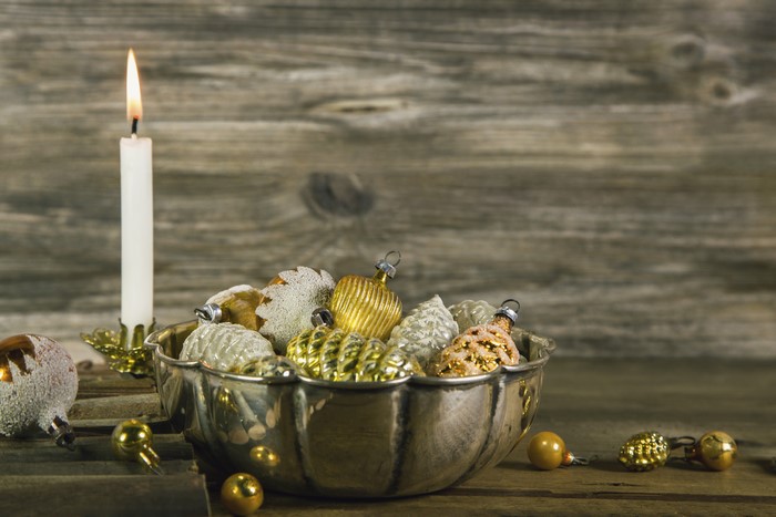 Christmas Ornaments in a Bowl with a Candle