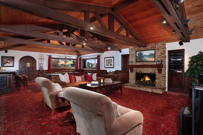 Living room with fireplace and pool table