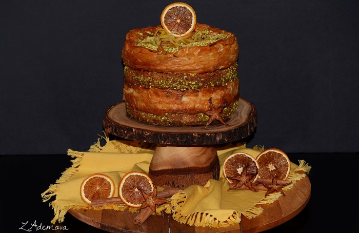 Layered baklava cake with pistachios and orange slice