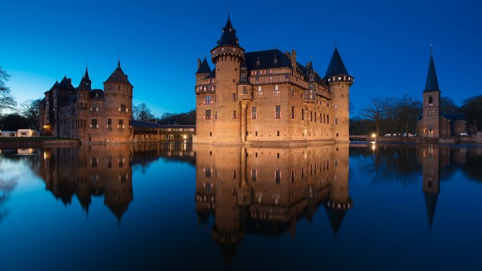 Castle De Haar reflected in water at night, Netherlands