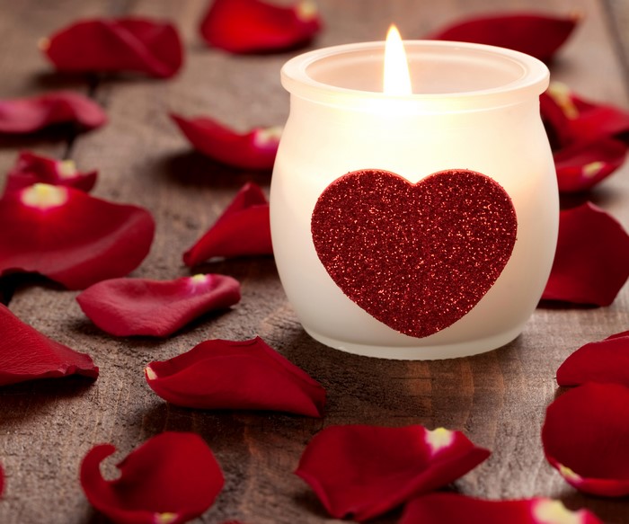 Candle with heart and rose petals