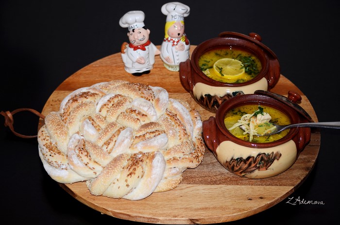 Braided bread and soup in pots