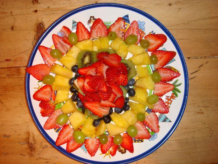 Fruit platter with strawberries, kiwi, blueberries, and grapes