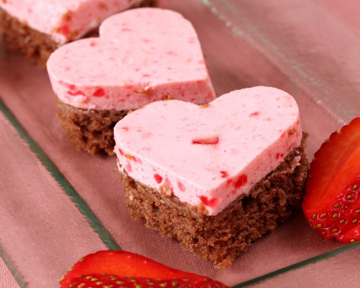 Heart-shaped strawberry mousse cakes with chocolate base