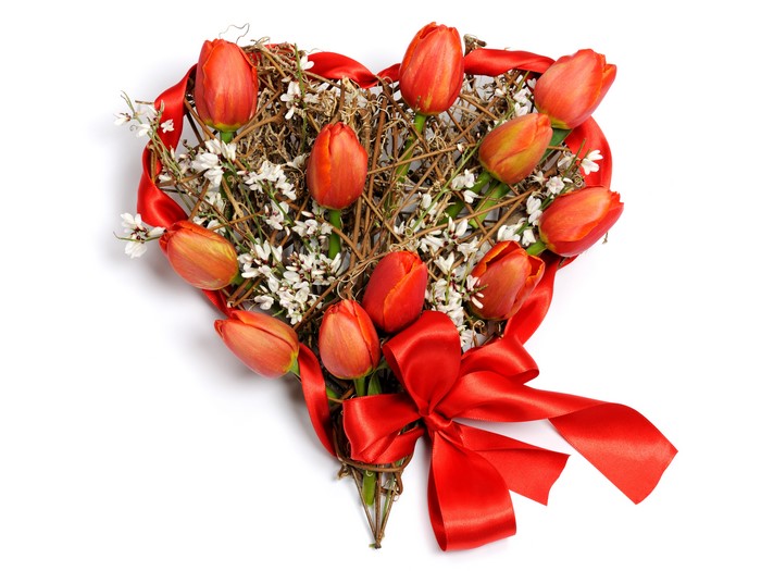 Heart-shaped wreath with red tulips and ribbon
