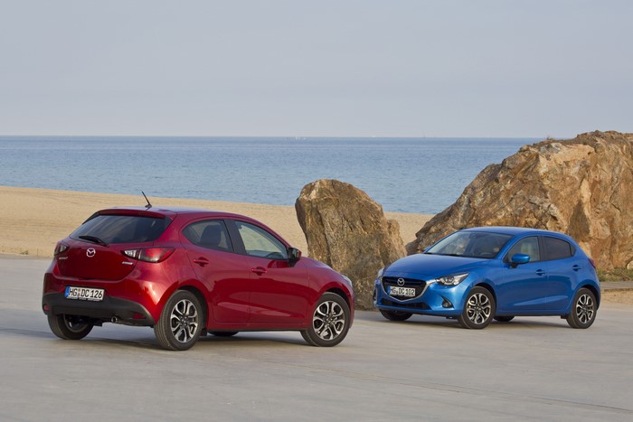 Two Mazda 2 cars by the sea