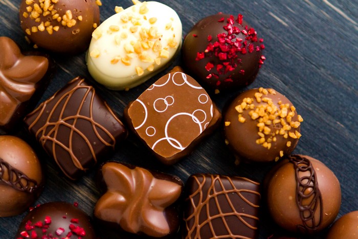 Assortment of chocolates on a dark wooden surface