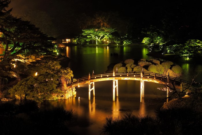 Ritsurin Garden bridge over water at night