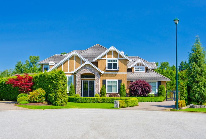 Luxury house with manicured landscaping and street light