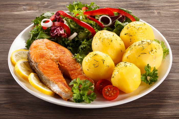 Salmon steak with potatoes and salad