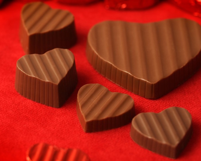 Heart-shaped chocolates on a red background