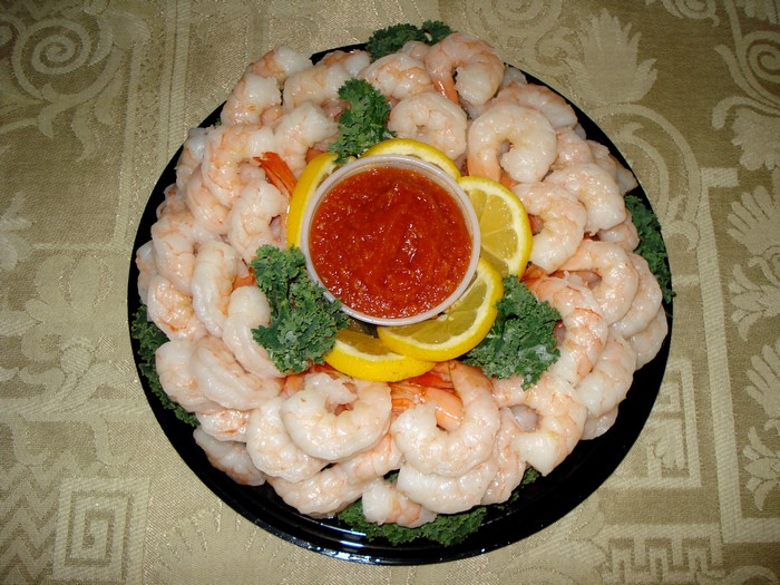 Shrimp platter with cocktail sauce and lemon slices