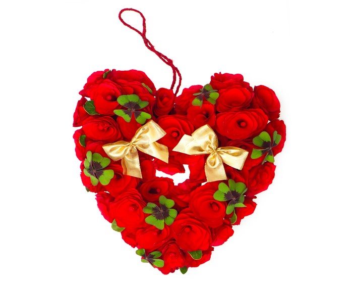Heart shape made of red roses with gold bows