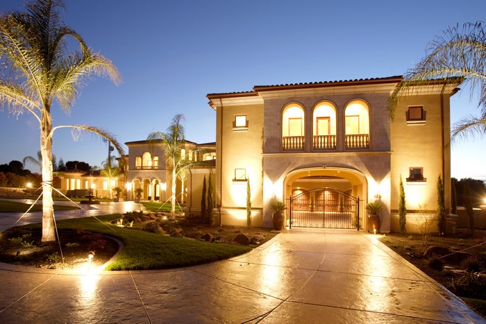Luxury Mansion with Palm Trees at Night