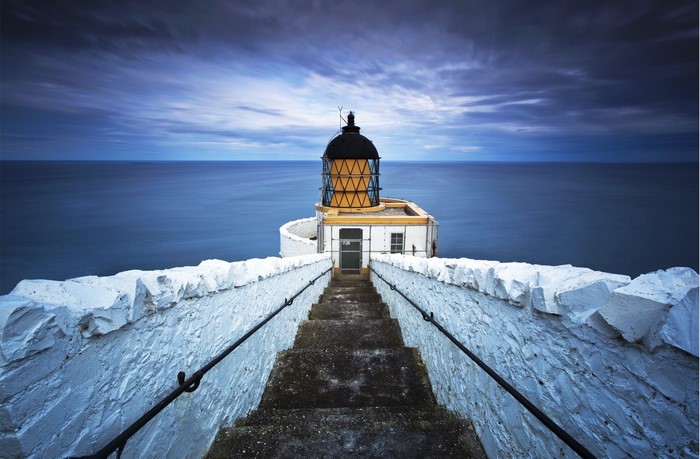 Lighthouse with stairs leading to the sea