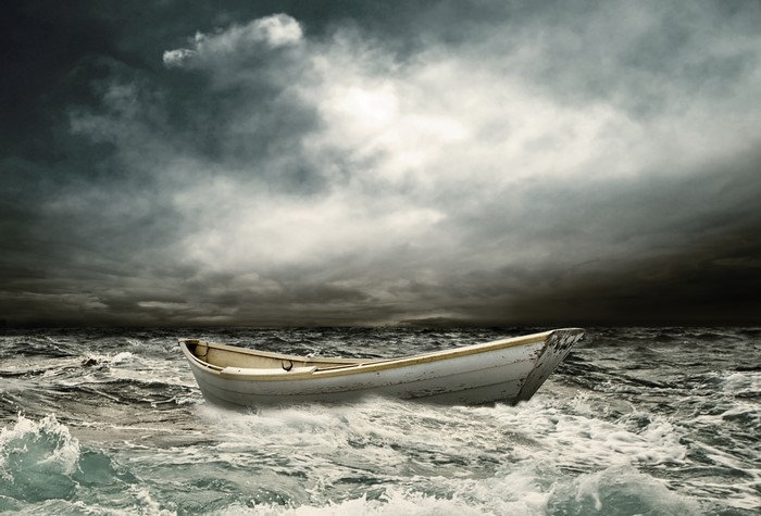 A lone boat on stormy seas under thunderclouds