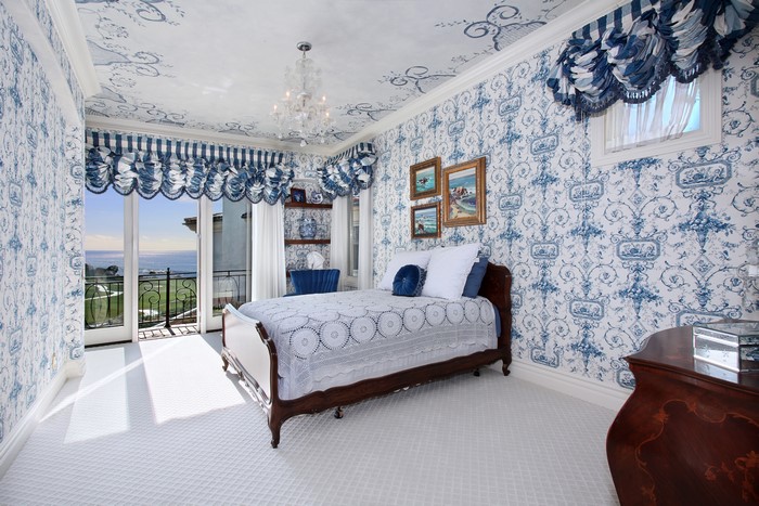 Blue and white toile bedroom with ocean view