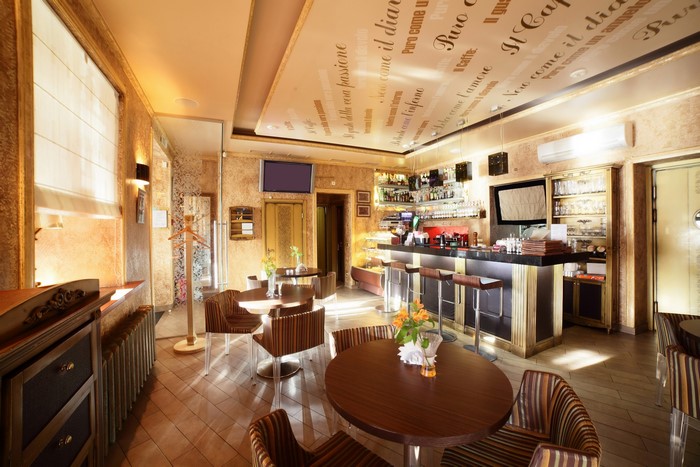 Interior of a cafe with tables and a bar