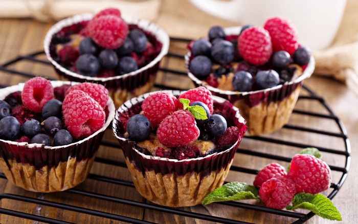 Berry muffins with raspberries and blueberries on a cooling rack