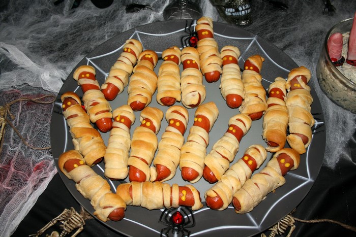 Halloween mummy hot dogs on a spiderweb plate