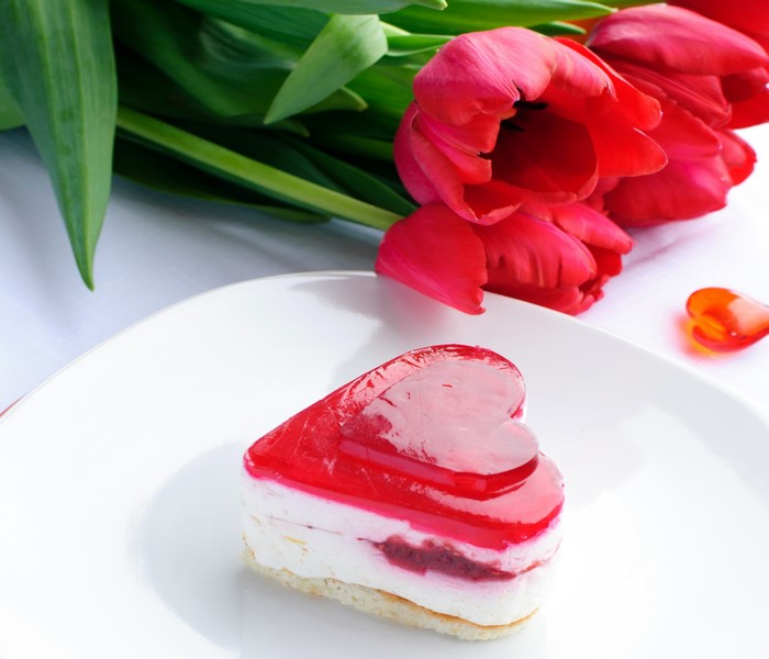 Heart-shaped cake with red tulips