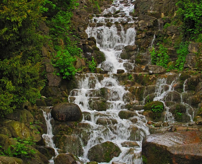 Waterfall cascading over rocks in Viktoriapark, Germany