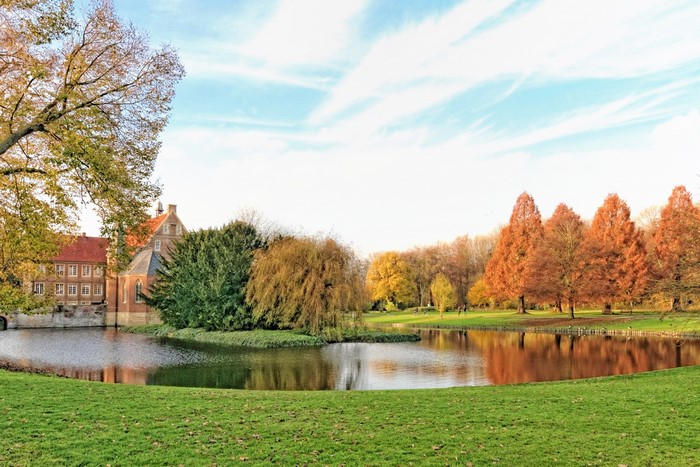 Castle with pond and autumn trees in Germany