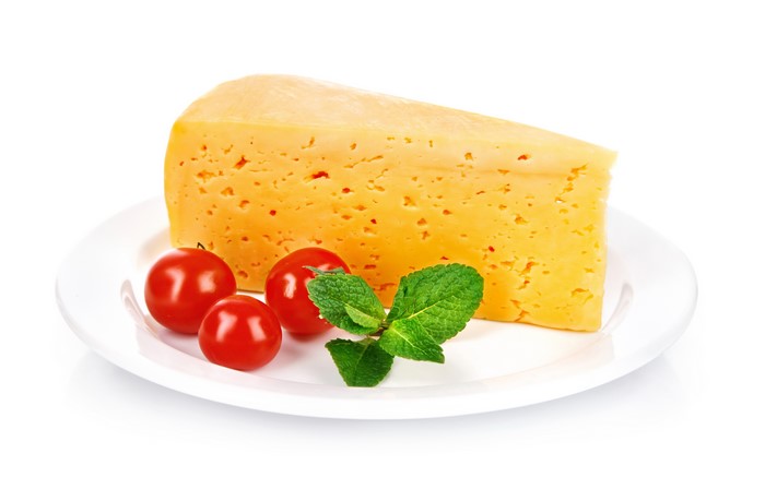 Cheese with tomatoes and mint on a plate