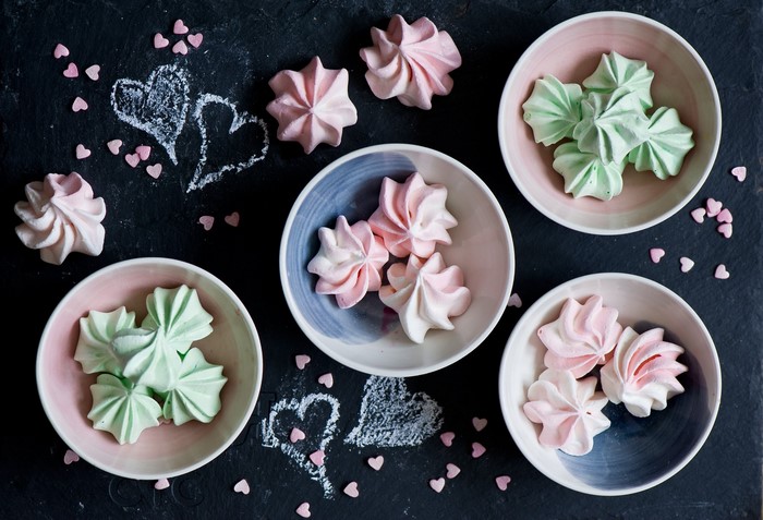 Pink and green meringues with heart sprinkles