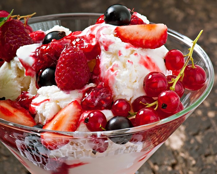 Ice cream sundae with strawberries, raspberries, and currants