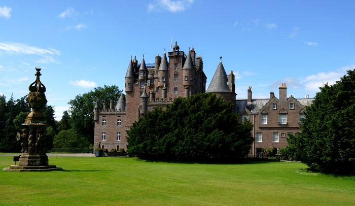 Glamis Castle with fountain and trees in Scotland