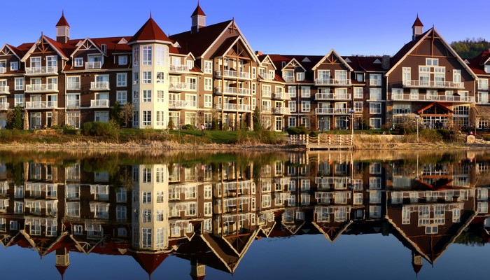 Large hotel building reflected in a calm lake
