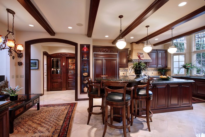 Luxury kitchen with dark wood cabinets and island