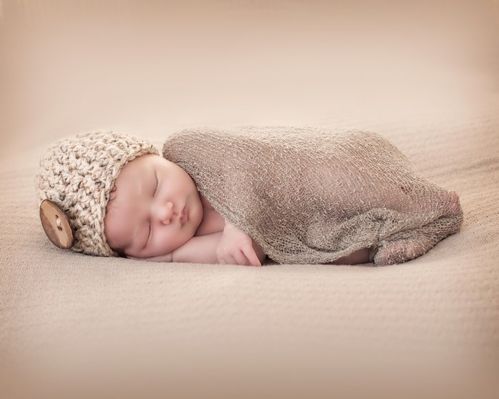 Newborn baby sleeping in a knitted hat