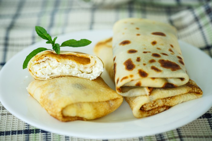 Pancakes with cottage cheese filling on a plate