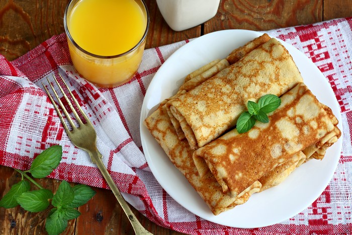 Pancakes with orange juice and mint