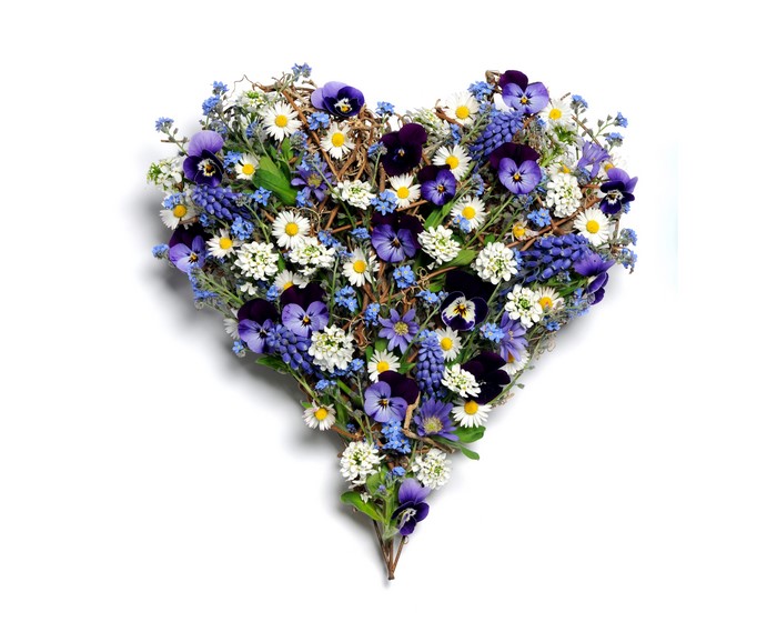 Heart-shaped floral arrangement with pansies and daisies