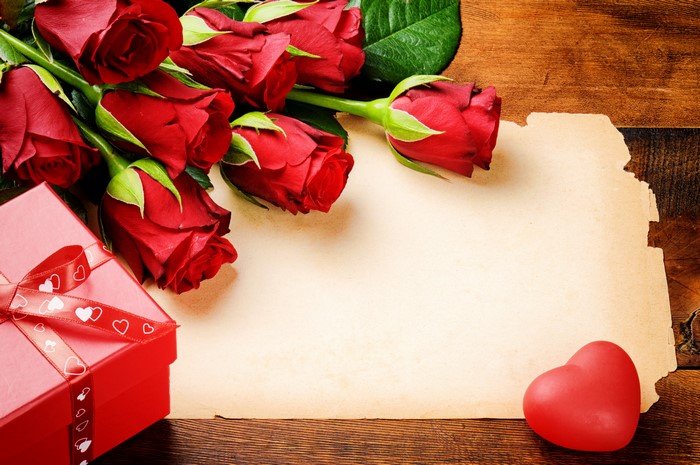 Red Roses, Gift Box, Heart, and Parchment on Wood