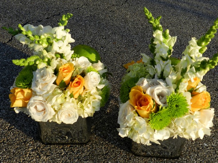 Two floral arrangements with roses and snapdragons