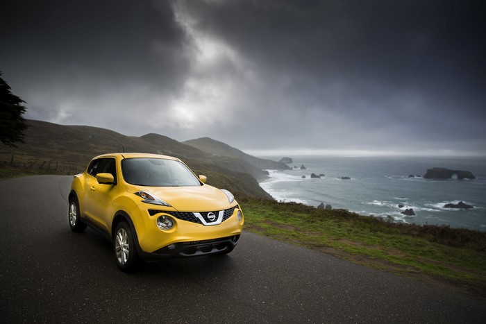 Yellow 2015 Nissan Juke on a coastal road