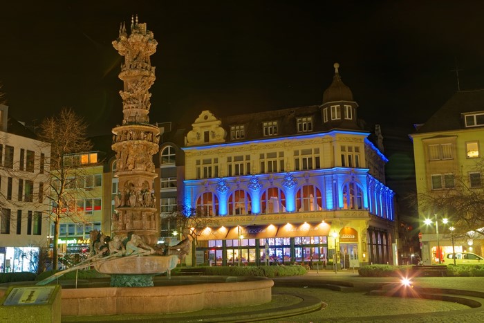 Fountain and buildings in Koblenz, Germany at night