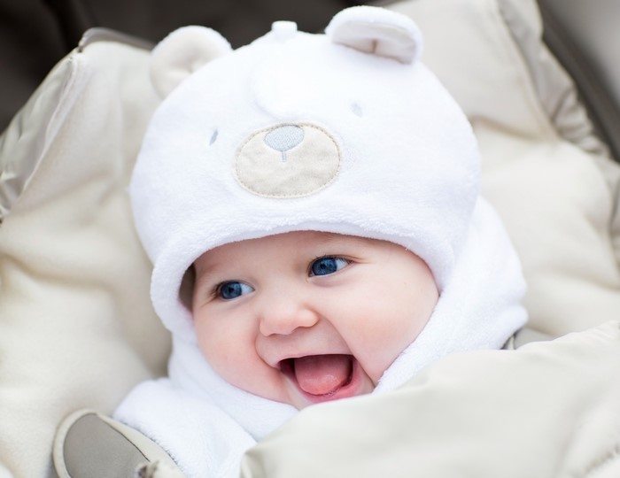 Baby wearing a white bear hat