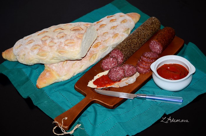 Bread, Sausage, and Ketchup on a Cutting Board