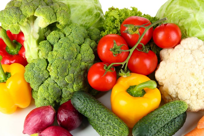 Assortment of fresh vegetables including broccoli, tomatoes, and bell peppers
